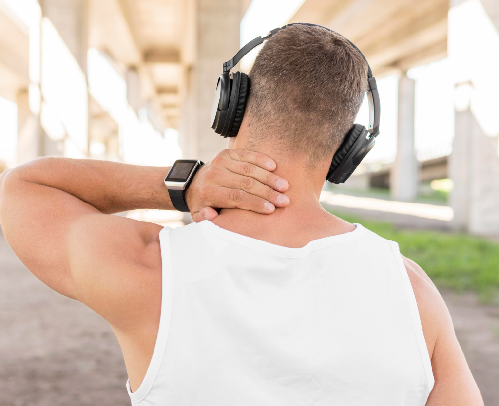 Man With Neck Pain Wearing Headphones