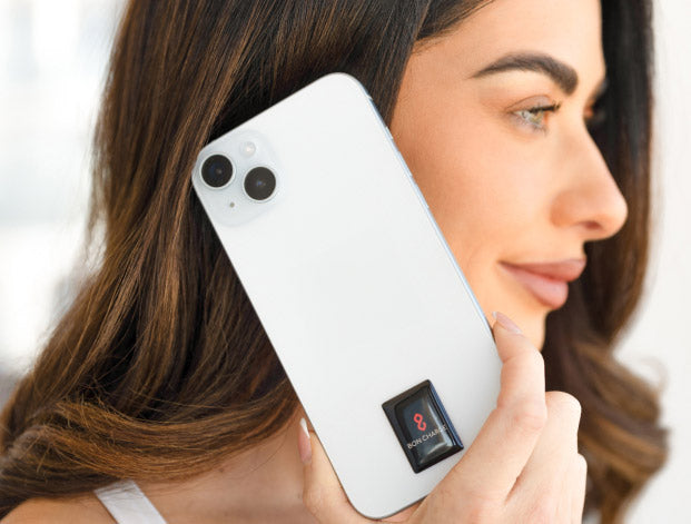 Woman Up Holding Phone To Ear Showing Harmonising Sticker