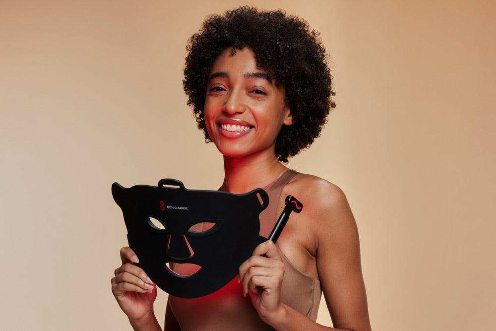 Woman Holding Red Light Face Mask