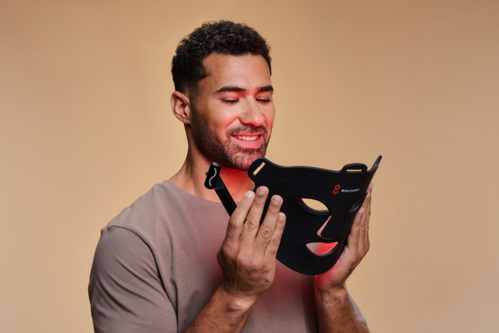 Man Holding Red Light Face Mask